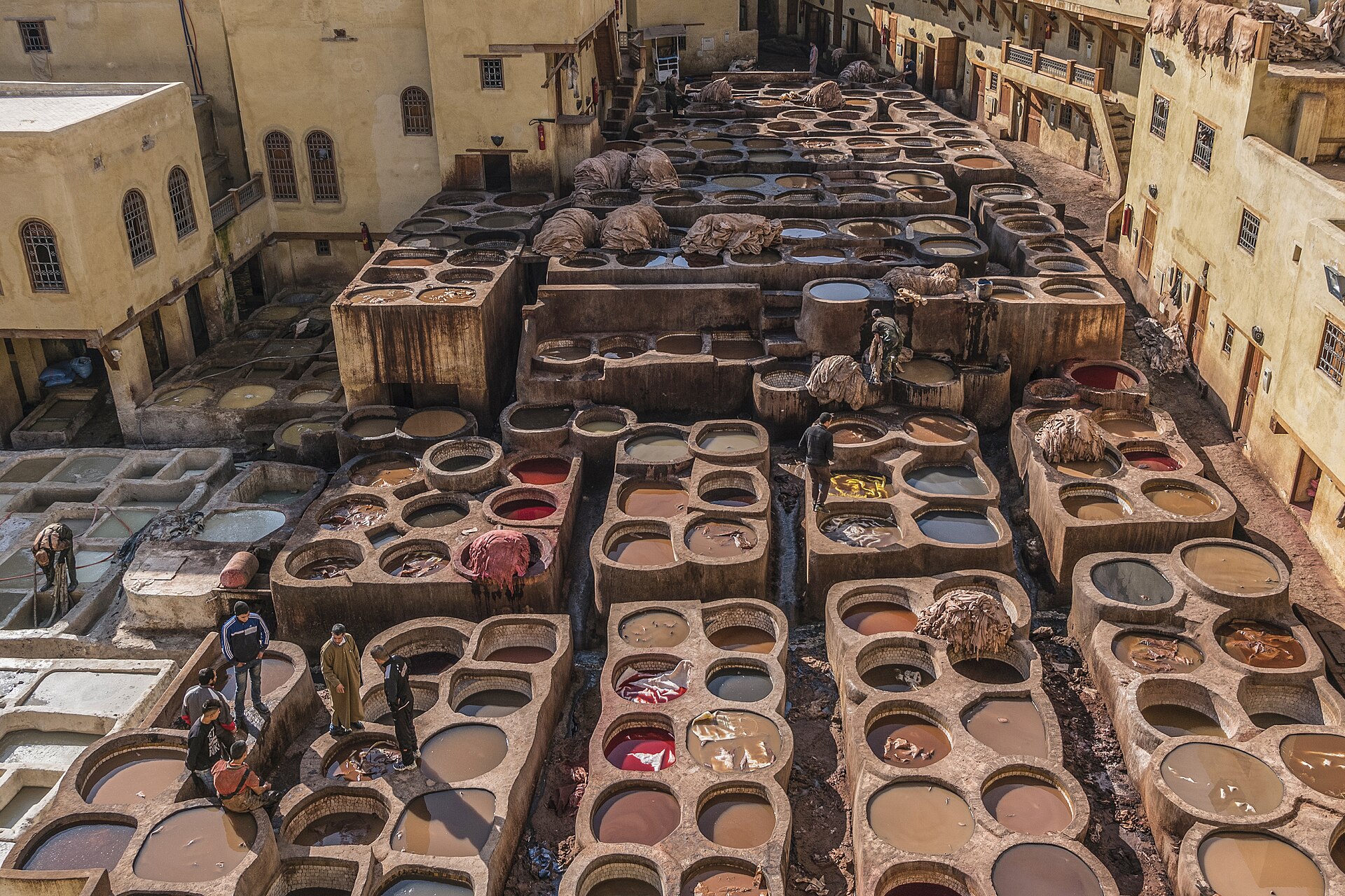 Leather tanning vats and workers in Fes, shown as place and craft context
